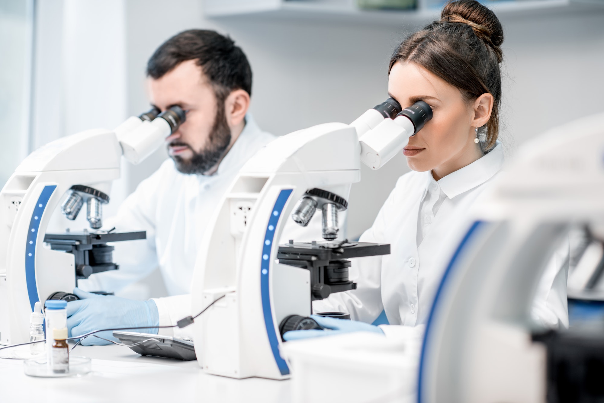 Medics working with microscope at the laboratory