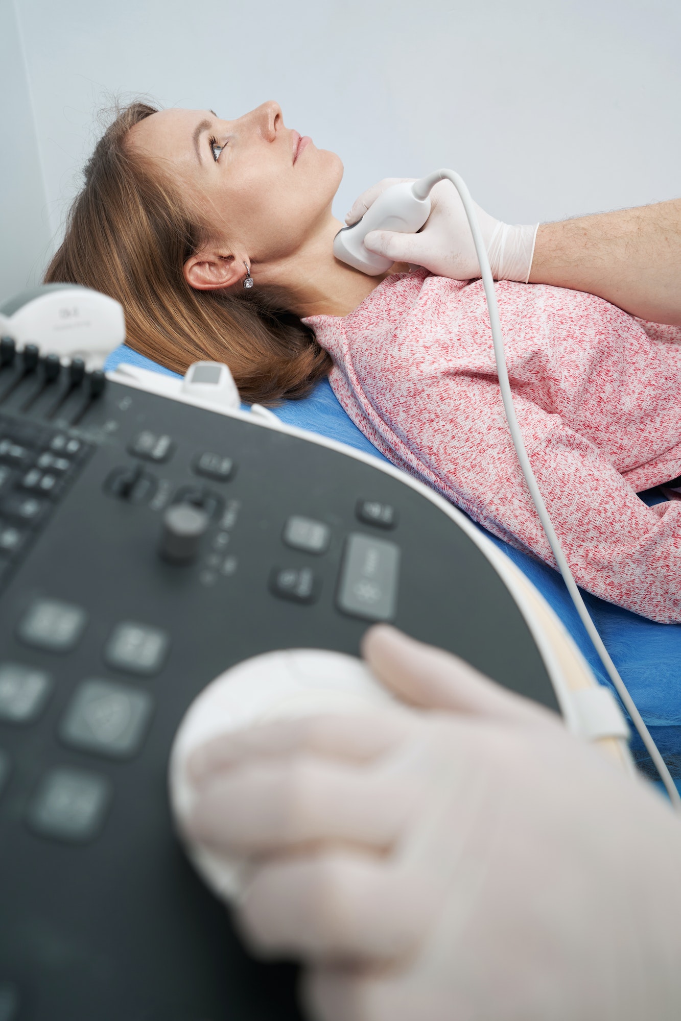 Thyroid scan of Caucasian woman lying on couch in endocrinology office